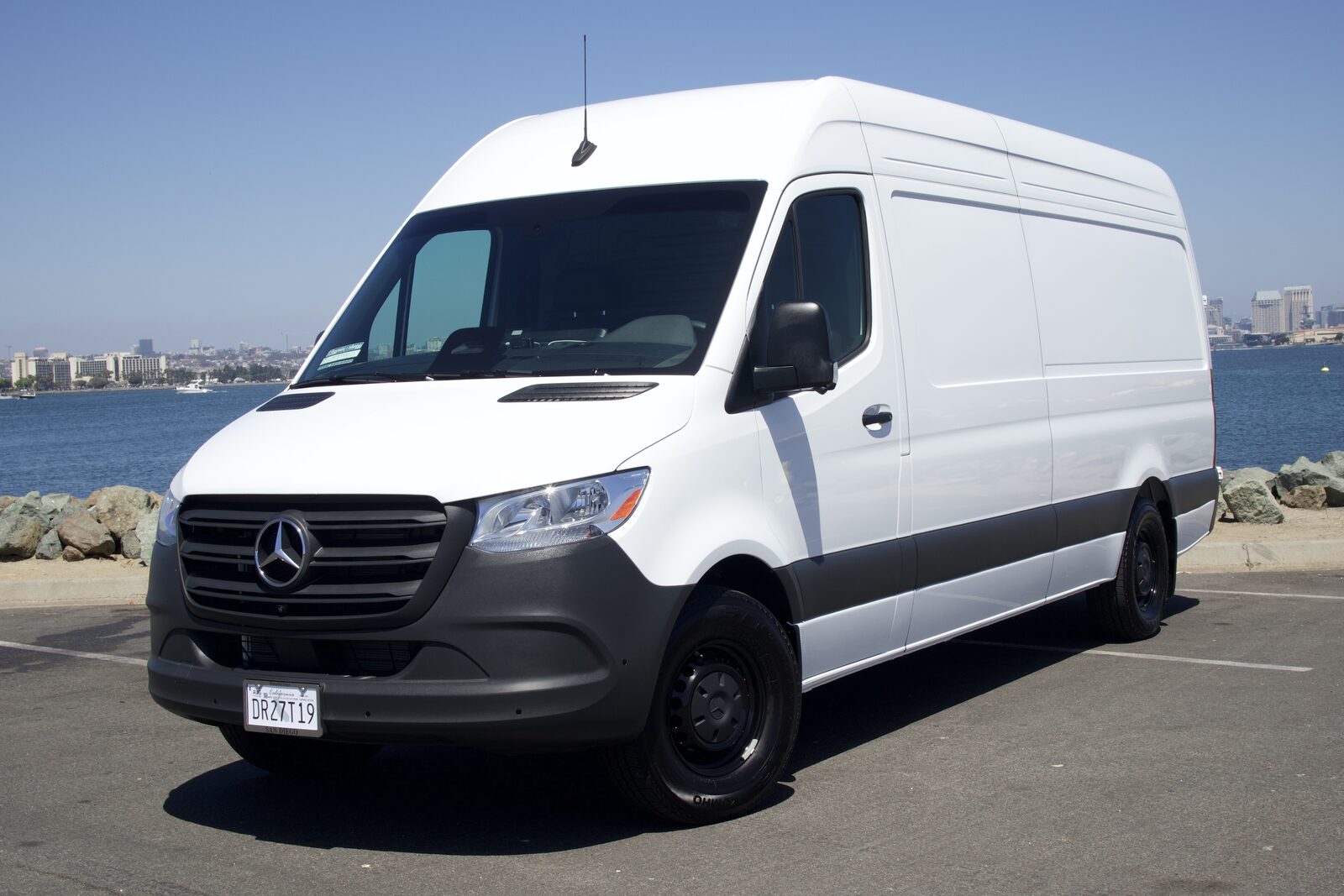 DETL Mercedes Sprinter detailing van parked along the San Diego bay with the downtown skyline behind it